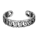 Om Mani Padme Hum titanium steel cuff bracelet with engraved six-word mantra, front view on white background