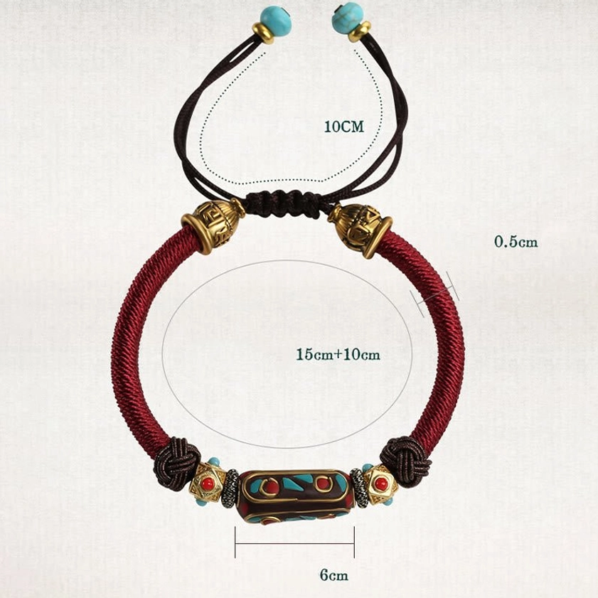 Front view flat lay of handmade turquoise Buddhist bracelet featuring burgundy woven rope, enamel mantra bead, adjustable pull cord and turquoise bead end decorations
