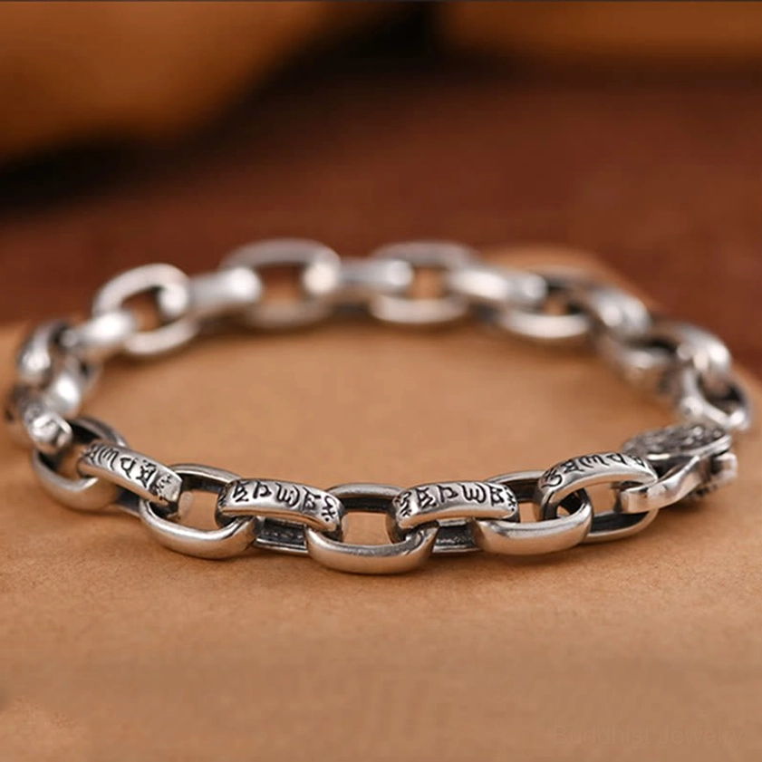 Handcrafted Buddhist copper bracelet overhead view showing complete oval linked chain with engraved Om Mani Padme Hum text