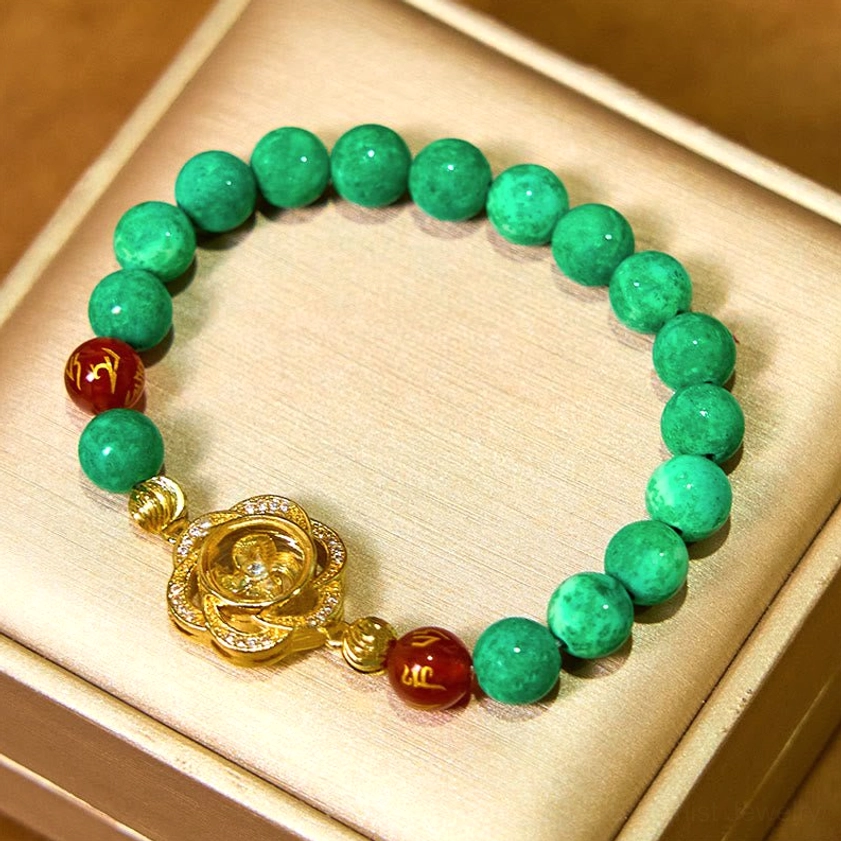 Buddhist jade prosperity bracelet with rotating rose charm displayed on beige luxury gift box