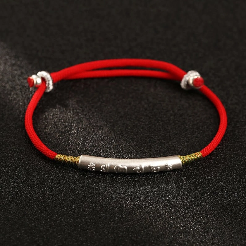 Gold-plated sterling silver Om Mani Padme Hum bracelet with red cord, close-up detail view