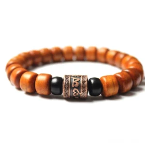 Om Mani Padme Hum bone beads bracelet with engraved metal charm on white background, front view