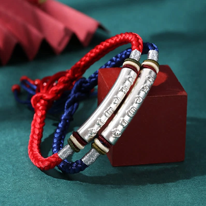 Two handmade Buddhist string bracelets in red and blue with matching 999 silver tubes featuring om mani padme hum mantra engraving