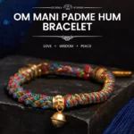 Om Mani Padme Hum multicolored Buddhist string bracelet with gold bell charm on dark display platform