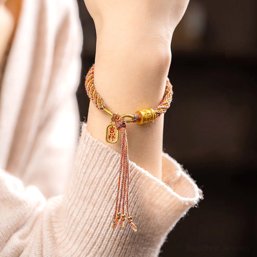 Buddhist meditation bracelet on wrist featuring Om Mani Padme Hum mantra with auspicious metal tag
