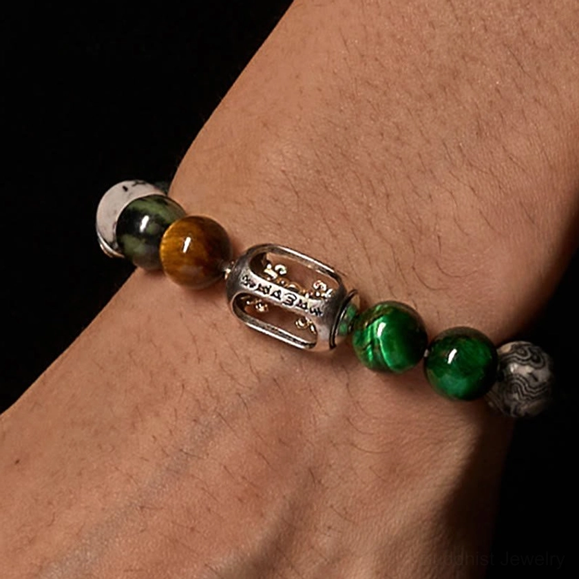 Om Mani Padme Hum healing bracelet worn on wrist showing natural stone beads and engraved copper metal charm close-up detail