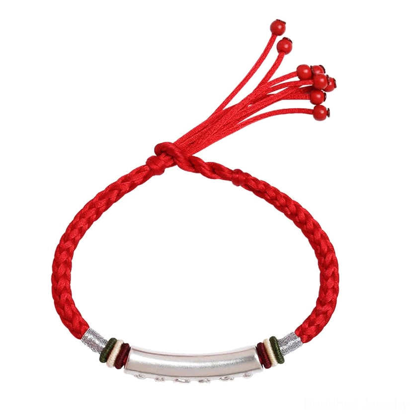 Handmade om mani padme hum Buddhist bracelet flat lay view with visible sacred text engraving on silver tube red adjustable closure