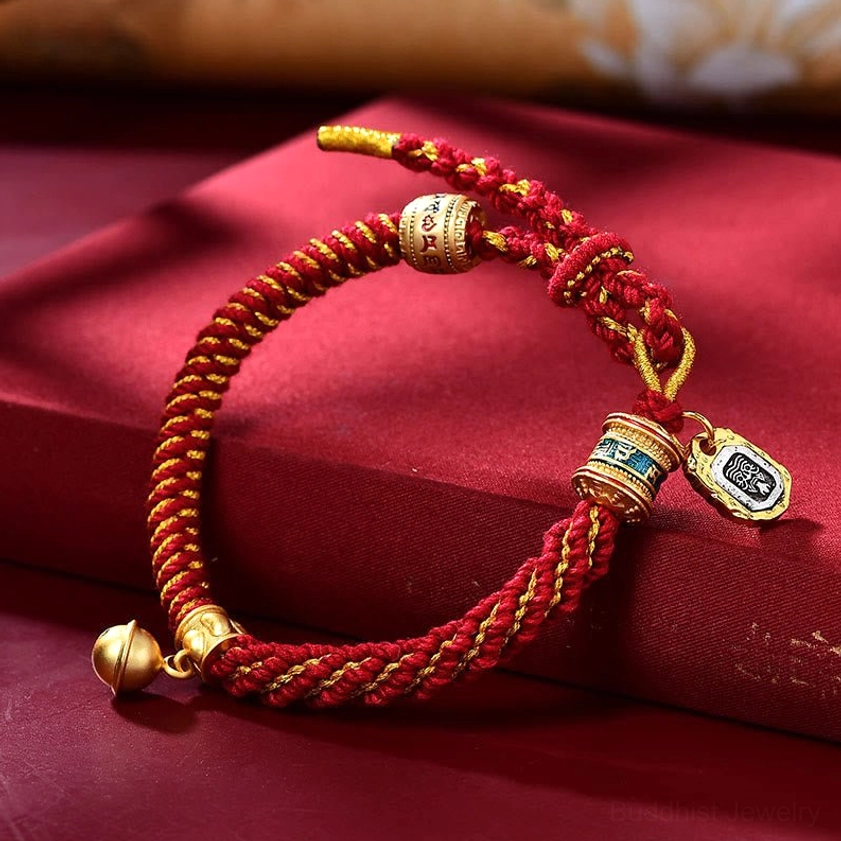 Red silk braided Buddhist mantra bracelet with engraved Om tag charm and protective bell pendant