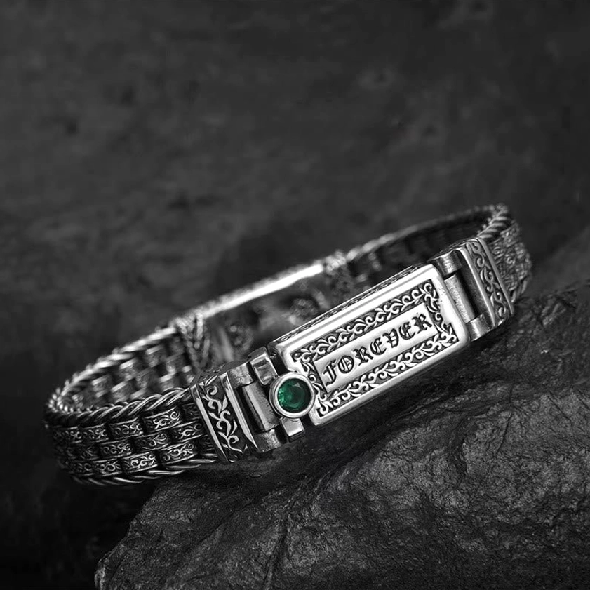 Buddhist Om Mani Padme Hum copper bracelet, side profile close-up showing intricate floral carving and green gemstone accent