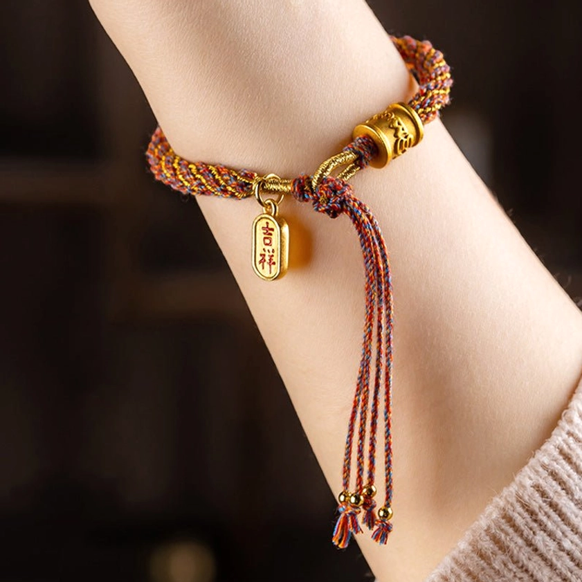 Sacred Om Mani Padme Hum braided bracelet side view showing Ruyi charm metal tag and adjustable rope