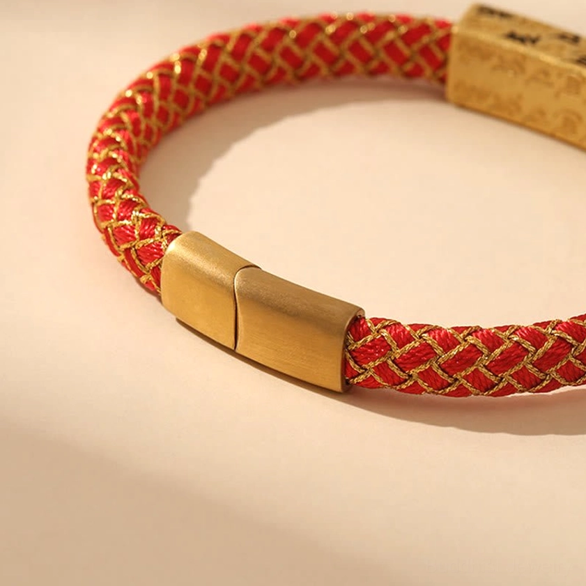 Red and gold Om Mani Padme Hum bracelet side angle view showing diamond knot gold clasp detail