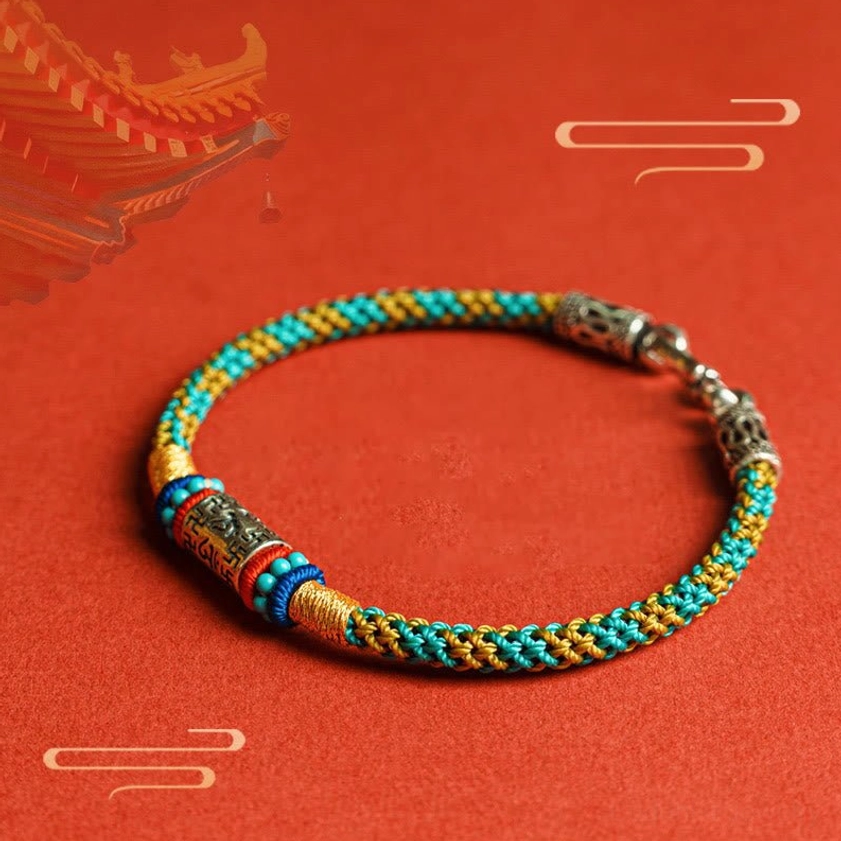Six True Words Buddhist bracelet with multicolor woven threads and silver engraved charm, side perspective