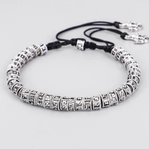Handmade Om Mani Padme Hum mantra bracelet with engraved silver alloy beads and black cord, side oblique view