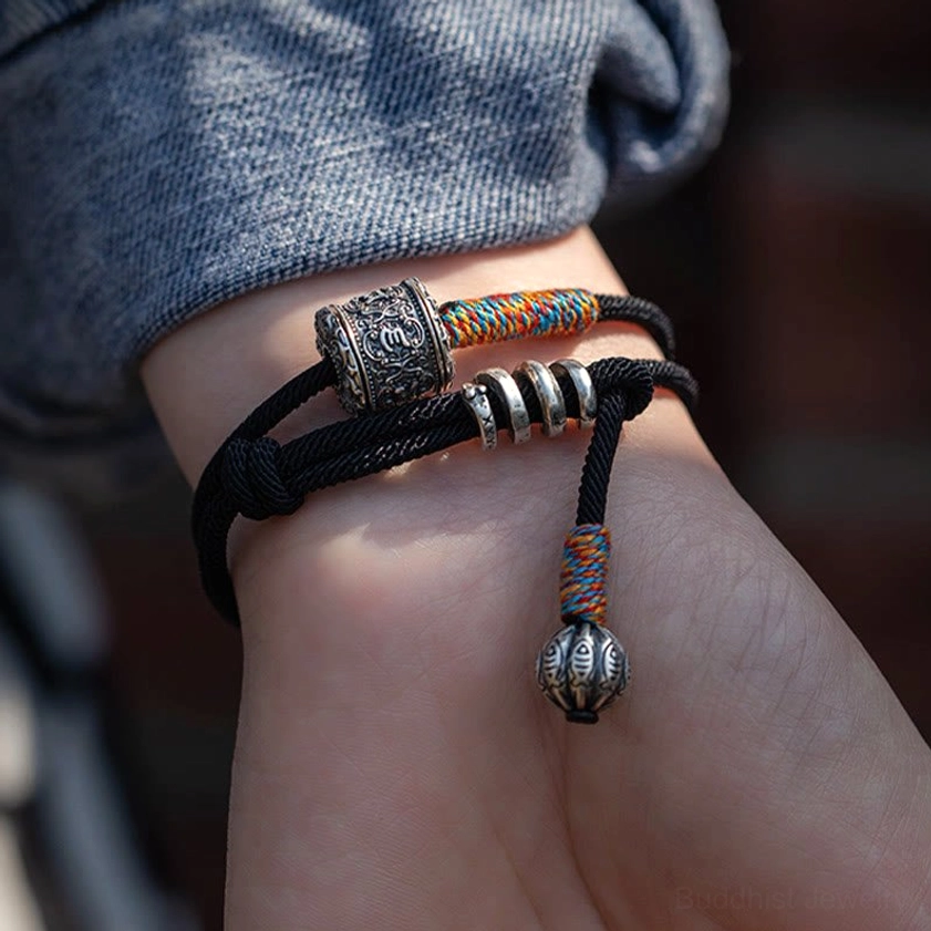 Om Mani Padme Hum meditation bracelet showing secure slip knot fastening with decorative silver rings