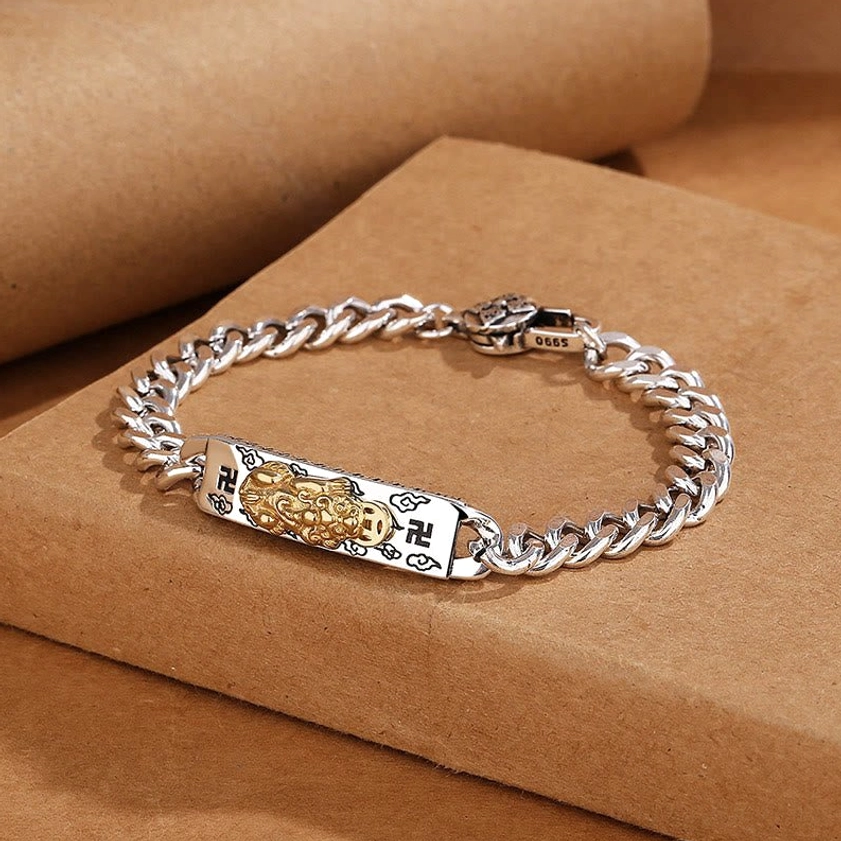 Sacred mantra bracelet featuring Pixiu charm with swastika engraving - three-quarter angle detail shot