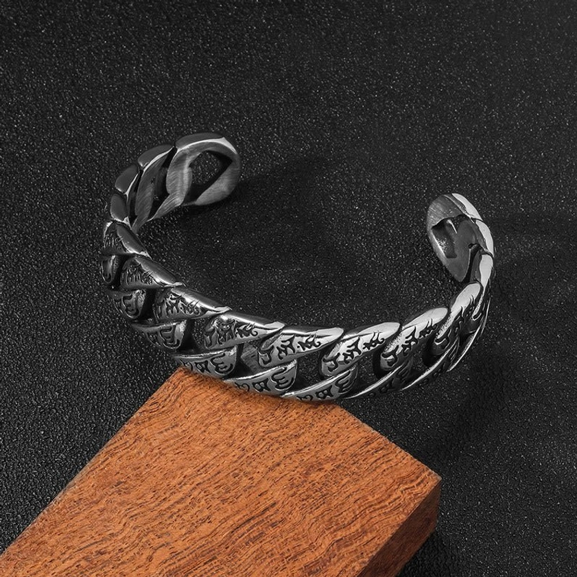 Engraved Om Mani Padme Hum titanium bracelet top view displaying twisted curb chain structure and open cuff design