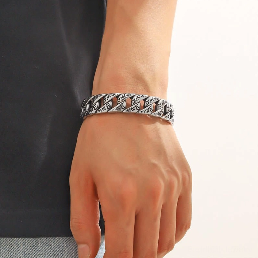 Woman wearing Om Mani Padme Hum titanium cuff bracelet on wrist showing fit and vintage silver tone