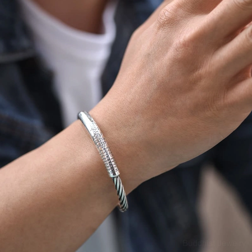 Wrist wear demonstration of Om Mani Padme Hum mantra bracelet showing slim fit and twisted rope design with sacred Buddhist text in daily casual setting