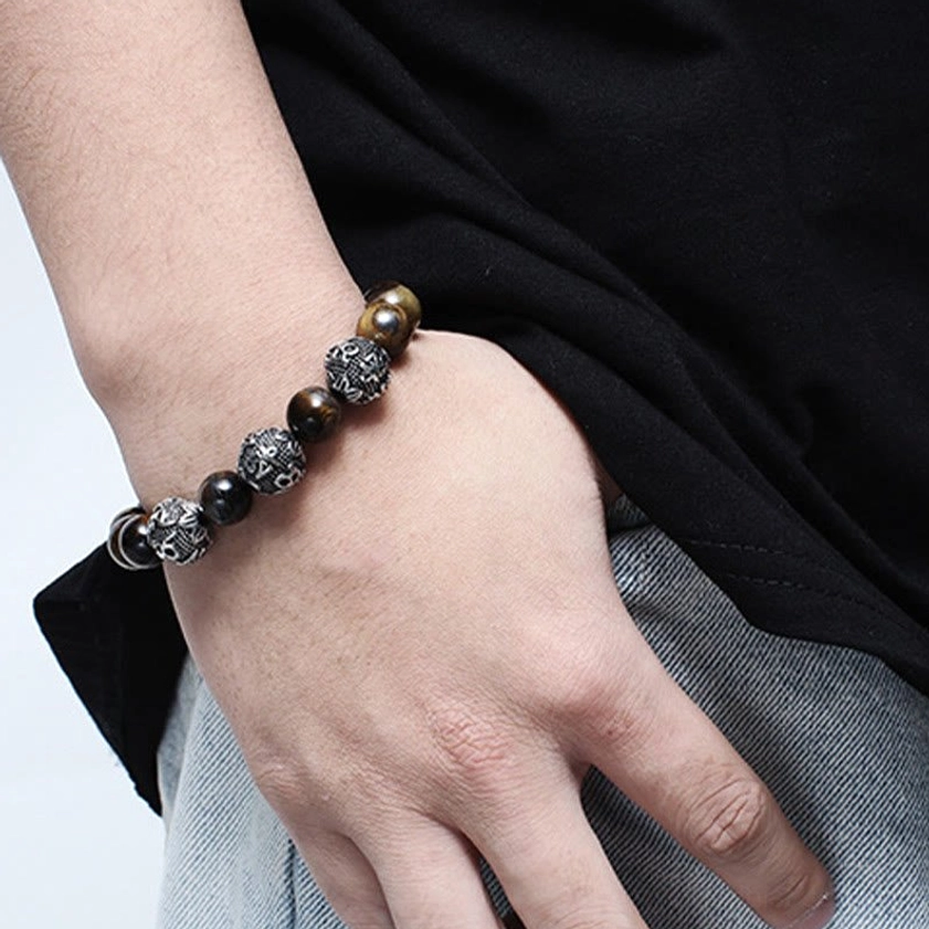 Handcrafted Buddhist bracelet worn on wrist in daily wear setting showing natural metal and stone beads in casual lifestyle