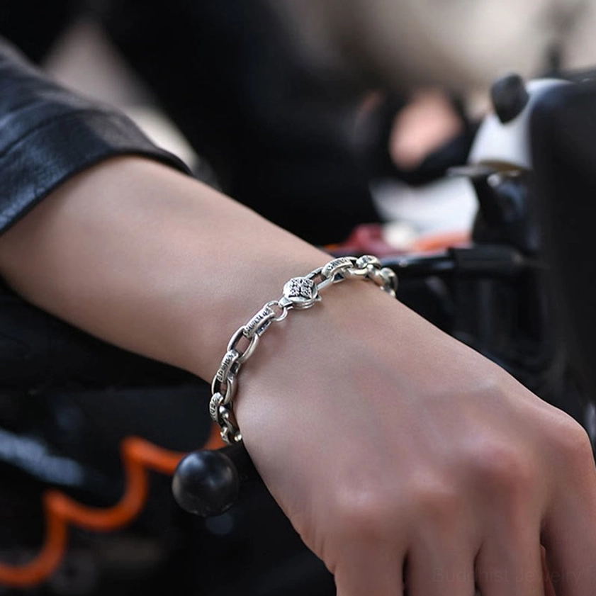 Six true words sterling silver bracelet worn on wrist with black bead accent detail in casual indoor setting