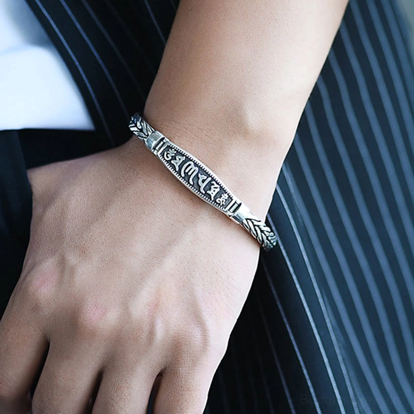 Buddhist copper bracelet worn on wrist with vintage silver finish, showing natural fit and integrated chain-to-plaque design