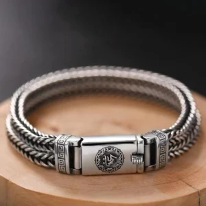 Om Mani Padme Hum braided copper bracelet with Six True Words buckle closure, overhead view showing twisted weave and ornamental details