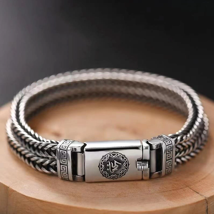 Om Mani Padme Hum braided copper bracelet with Six True Words buckle closure, overhead view showing twisted weave and ornamental details