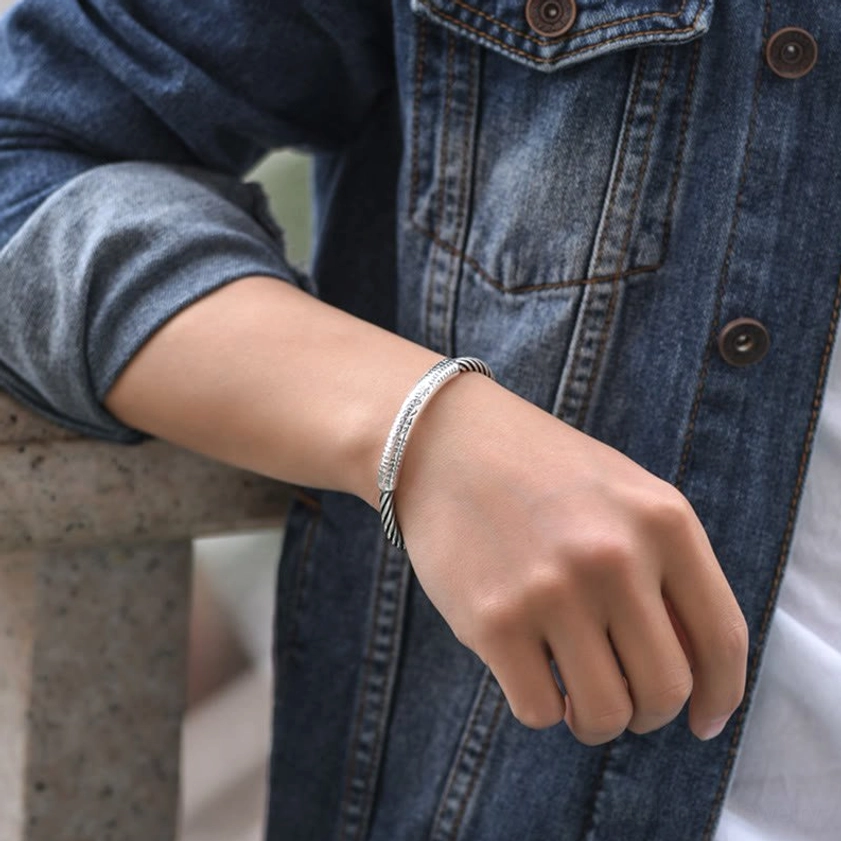 Buddhist bangle with Om Mani Padme Hum sacred text, twisted rope copper band design, traditionally crafted for meditation and spiritual protection