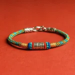 Om Mani Padme Hum Buddhist string bracelet with colorful woven threads and 925 sterling silver charm, front view