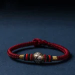 Om Mani Padme Hum Buddhist braided bracelet with 925 sterling silver charm and King Kong knot design, wine-red rope with colorful woven accents