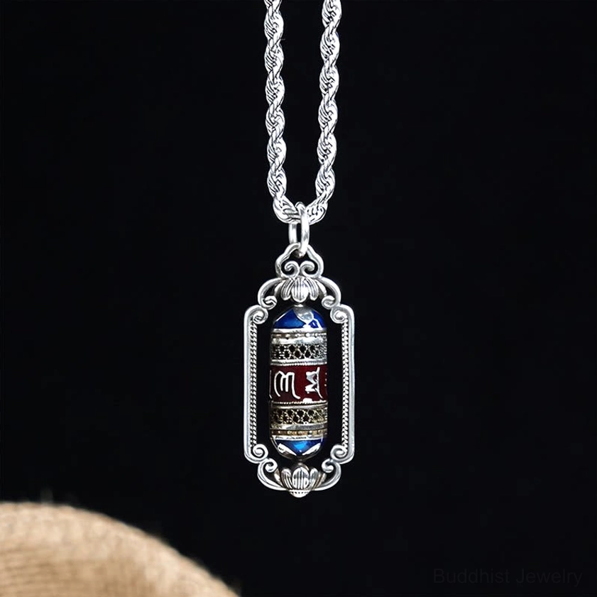 Buddhist Om Mani Padme Hum prayer wheel necklace featuring engraved mantra on copper pendant with ornate silver frame and twisted rope chain