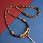 Om Mani Padme Hum Buddhist prayer necklace with King Kong knot pendant, carved gold bead and enamel details flat lay view