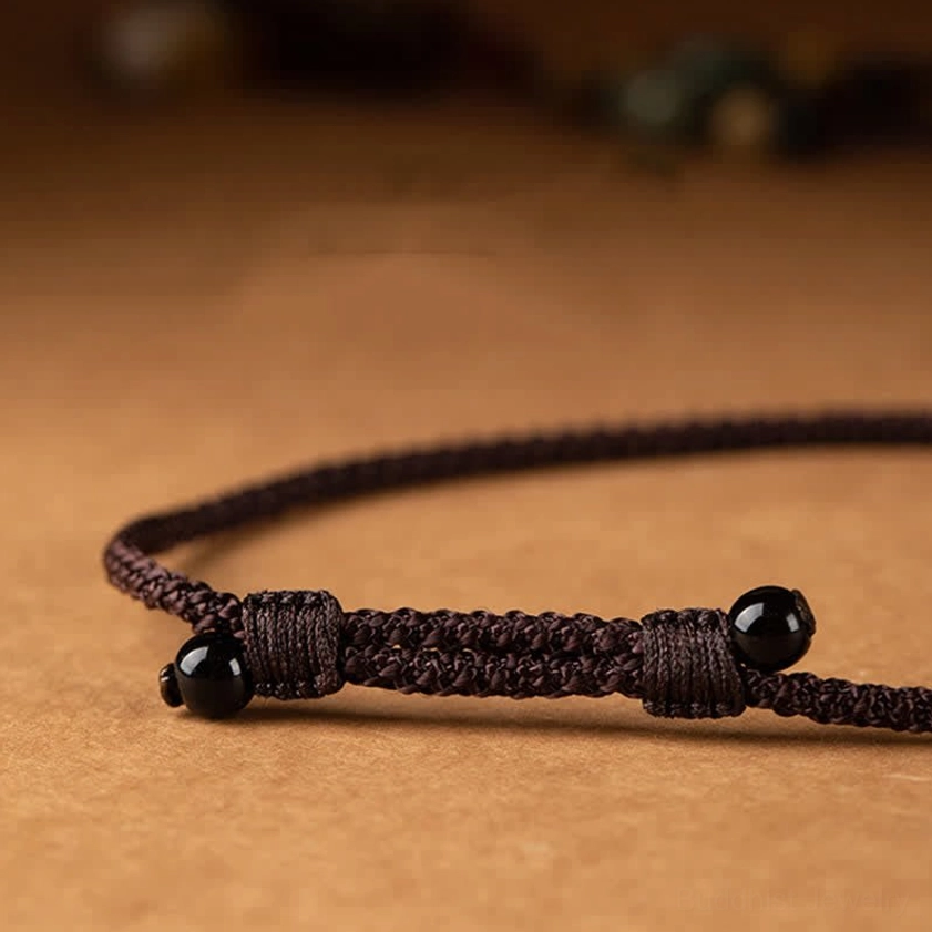 Sacred Buddhist mantra necklace with intricately carved bronze pendant and natural bodhi seed beads