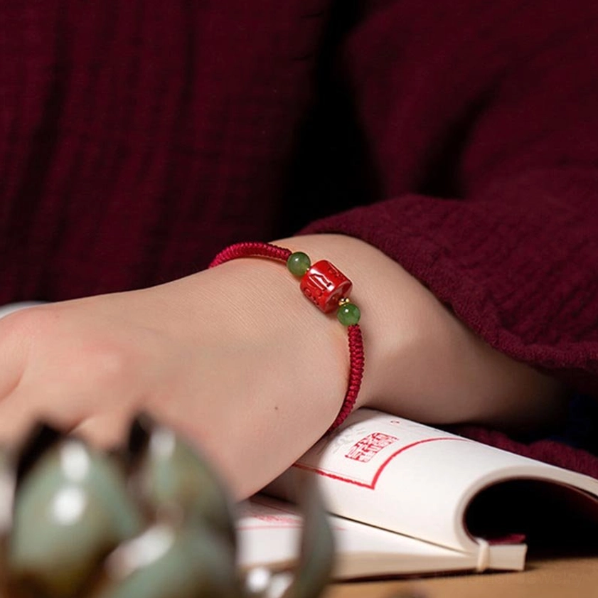 Om Mani Padme Hum sacred mantra engraved on natural cinnabar bead, Buddhist spiritual blessing bracelet detail