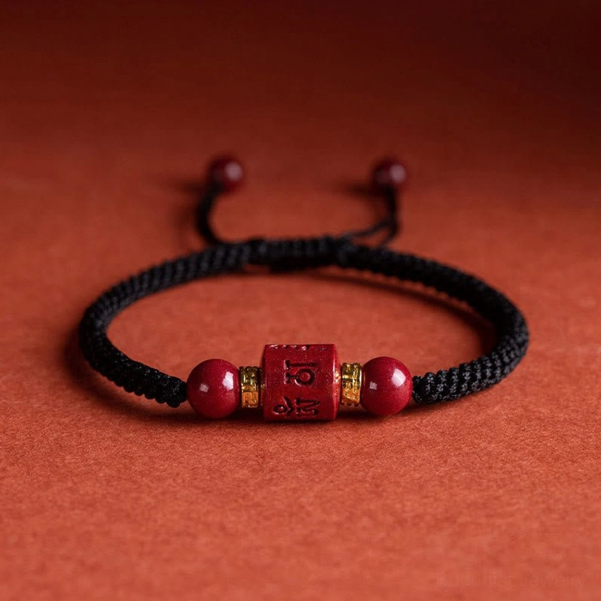 Black rope Om Mani Padme Hum cinnabar Buddhist bracelet with engraved mantra bead, cinnabar gemstones, and adjustable closure