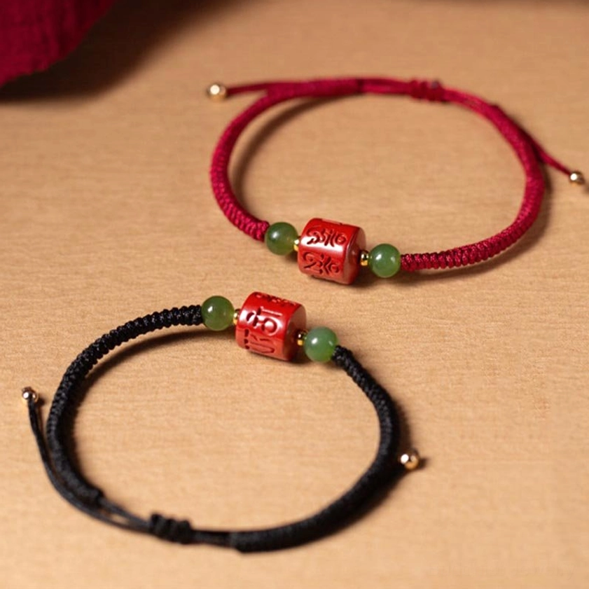 Two color options of Om Mani Padme Hum cinnabar bracelets - red rope and black rope variants with matching beads, flat lay comparison