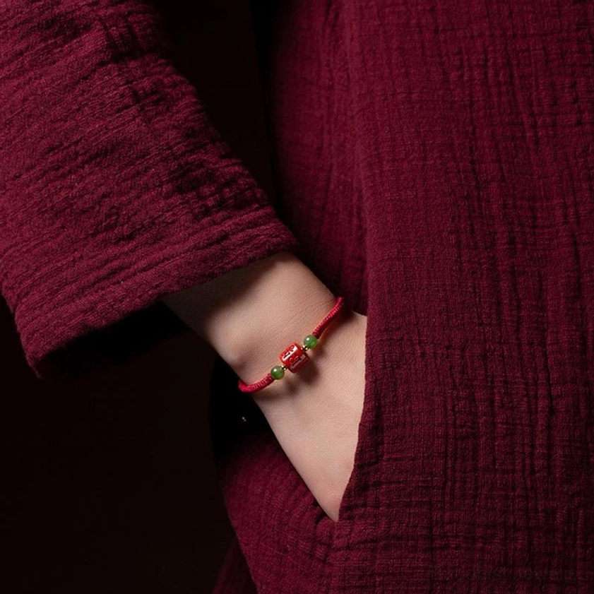 Om Mani Padme Hum cinnabar blessing bracelet being worn on wrist, demonstrating real wearing effect and comfort fit