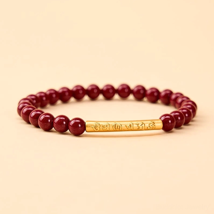Om Mani Padme Hum cinnabar sterling silver bracelet flat lay with engraved mantra tube, deep red beads on warm beige background