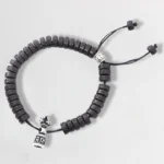 Om Mani Padme Hum coconut shell Buddhist bracelet with silver charm beads and adjustable elastic string