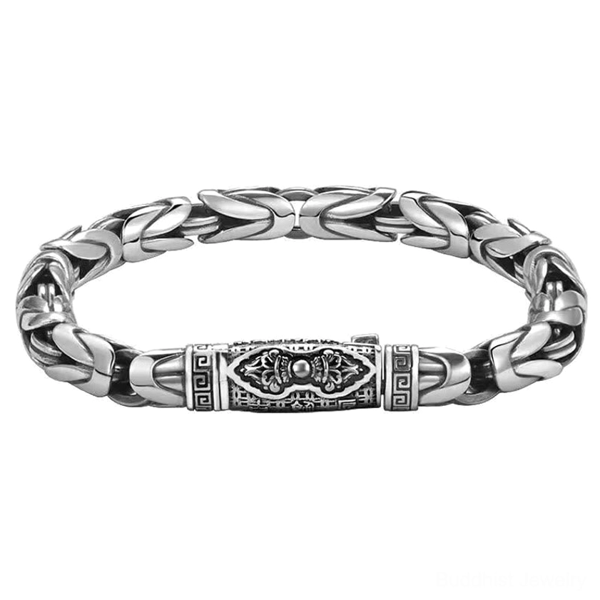 Handmade copper Buddhist bracelet featuring engraved patterned clasp and twisted wheat chain design, overhead flat lay