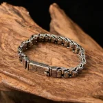 Om Mani Padme Hum copper bracelet flat lay top view showcasing engraved Buddhist mantra design on aged wood
