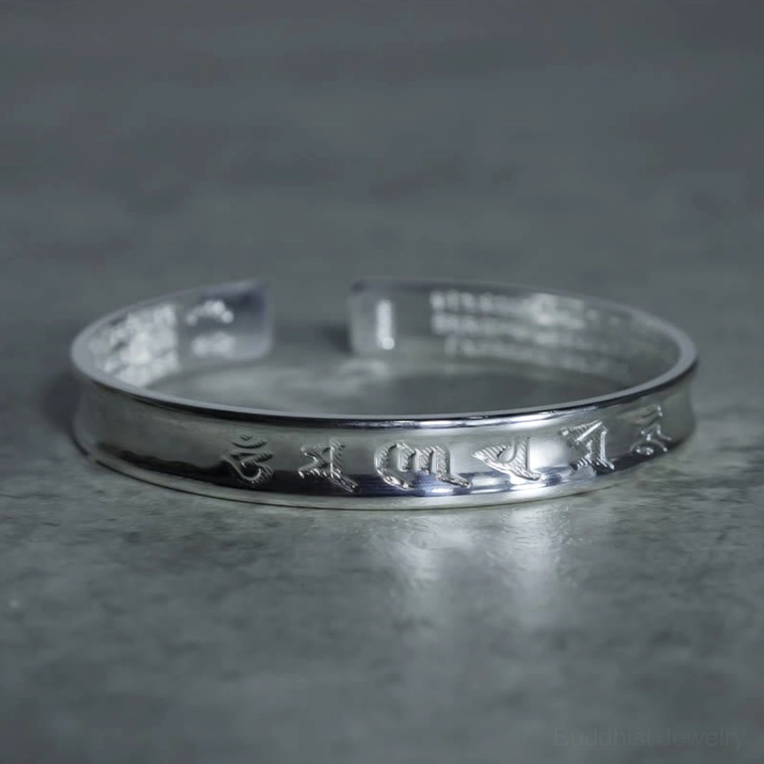 Sacred mantra copper bangle front flat lay view with full sutra engraving and open-ended cuff design