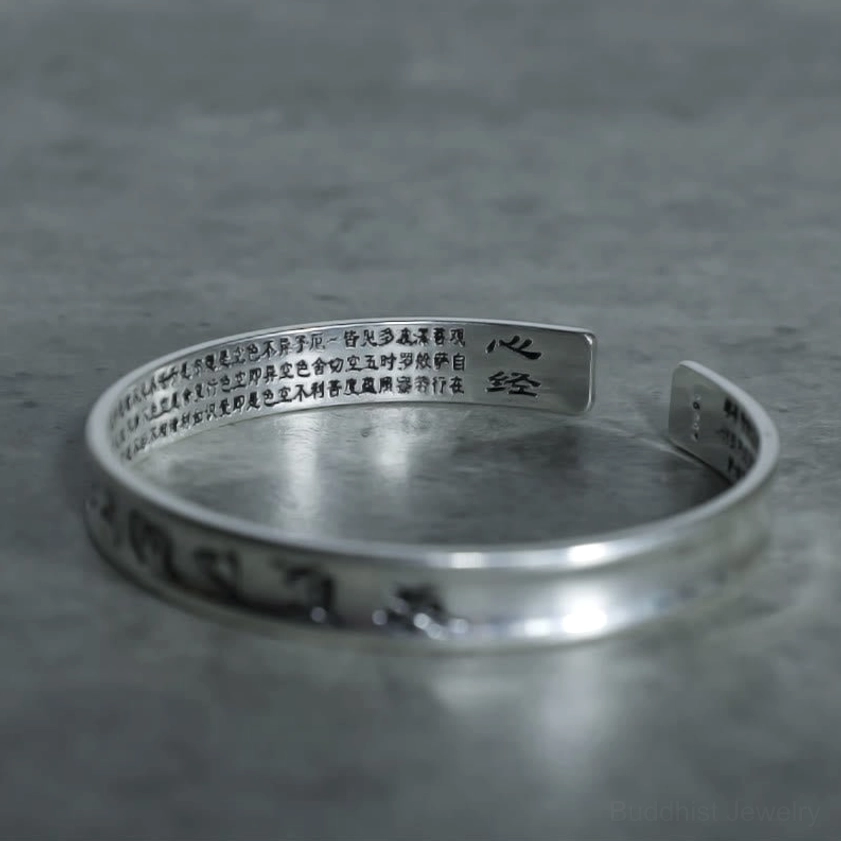 Buddhist sutra engraved copper bracelet top-down view displaying inner Heart Sutra text and mantra inscription