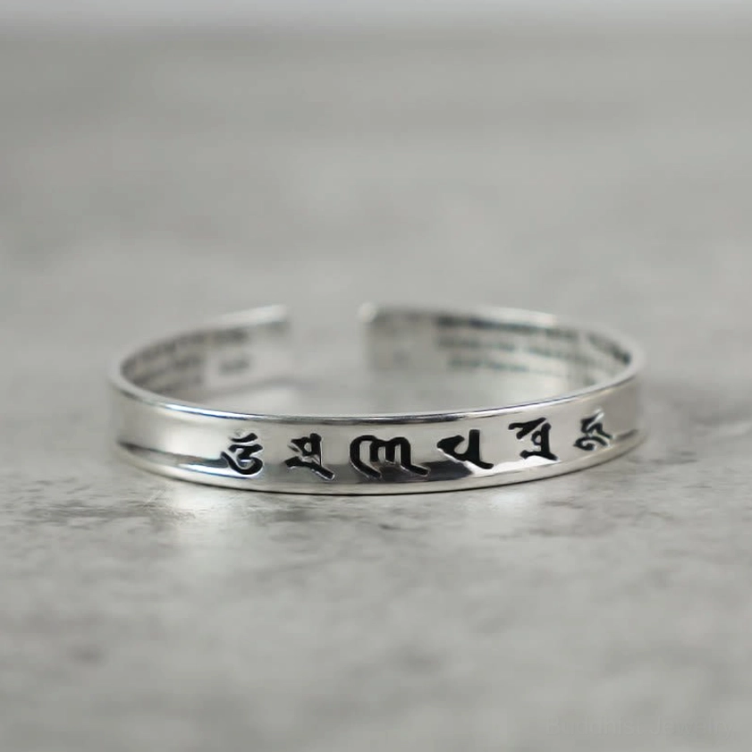 Om Mani Padme Hum copper mantra bracelet with black engraved sacred script, open cuff design front view
