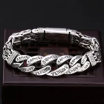 Om Mani Padme Hum engraved copper bracelet top view showing sacred mantra engravings on woven chain link design