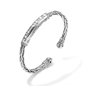 Om Mani Padme Hum engraved copper cuff bracelet with braided texture detail on white background