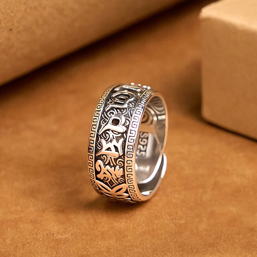Om Mani Padme Hum copper adjustable open ring with engraved Sanskrit mantras, top view on kraft paper background