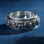 Om Mani Padme Hum copper spinner ring top front view showing engraved sacred mantra and swastika symbol
