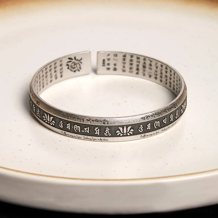 Om Mani Padme Hum bangle top-down flat lay showing inner and outer engravings with lotus mark detail