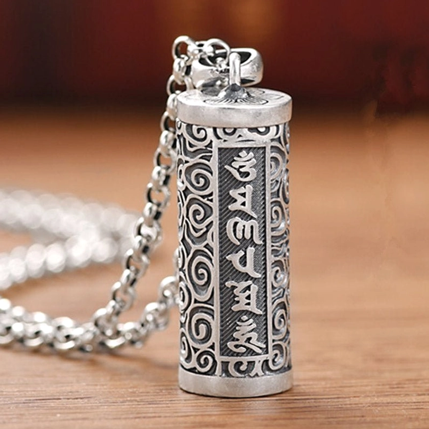 Om Mani Padme Hum cylinder pendant necklace with carved Sanskrit mantras and cloud patterns on wooden background - silver-plated copper Buddhist protection necklace